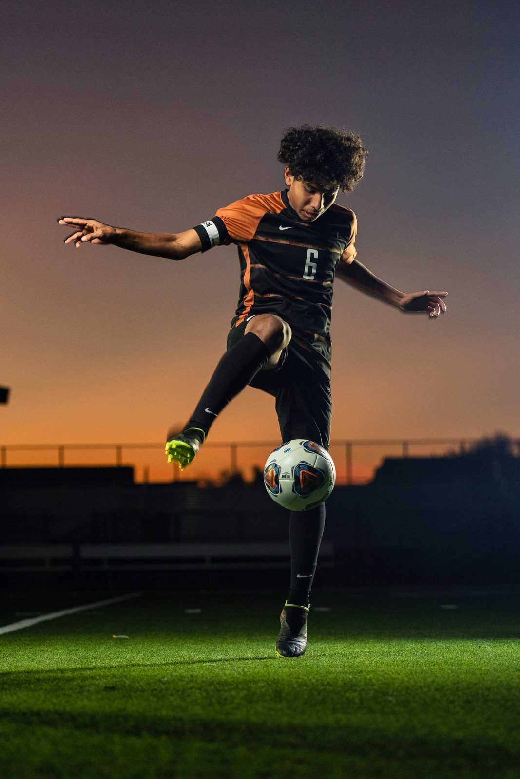 Soccer player action kick at sunset