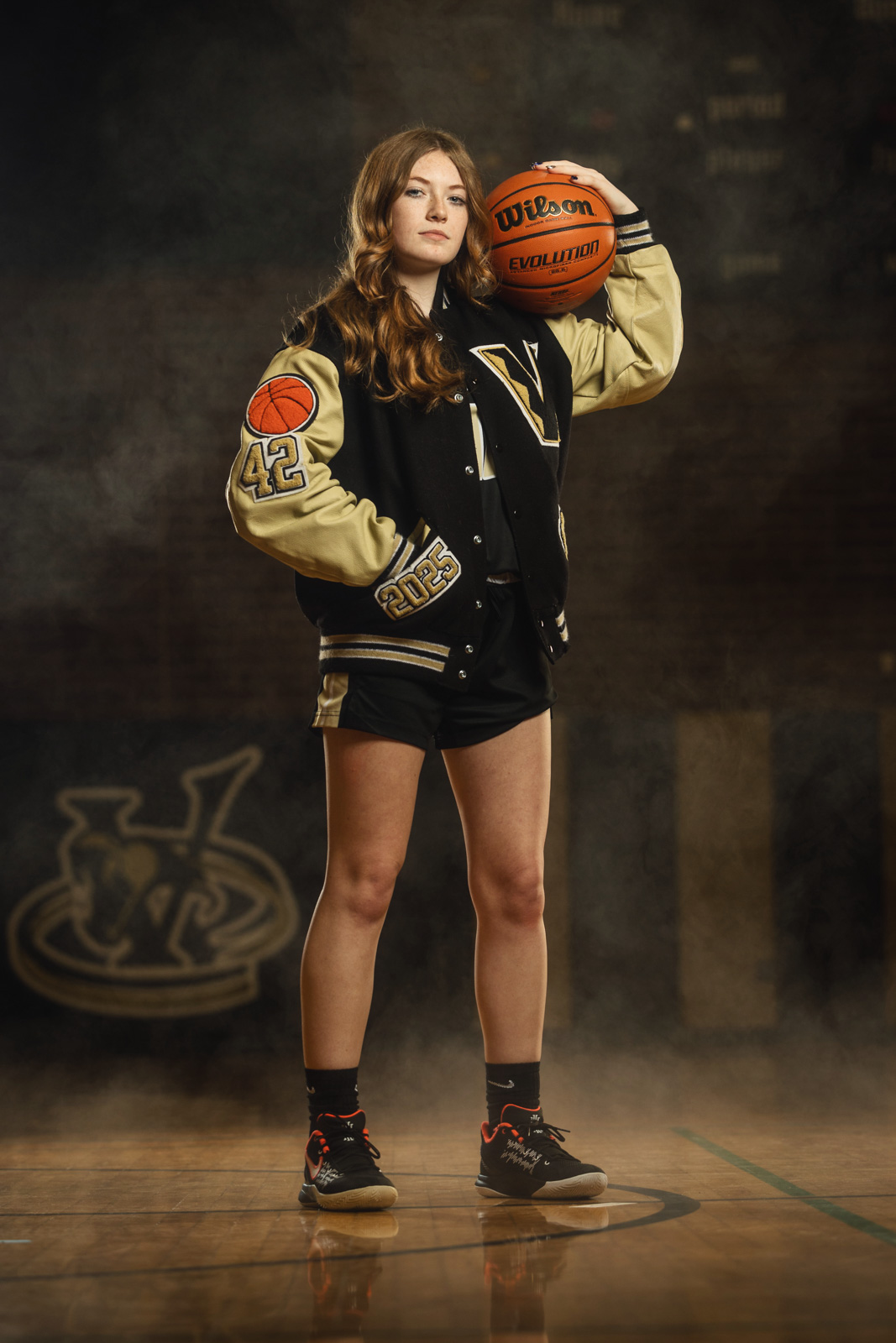 Basketball player in letterman jacket — portrait
