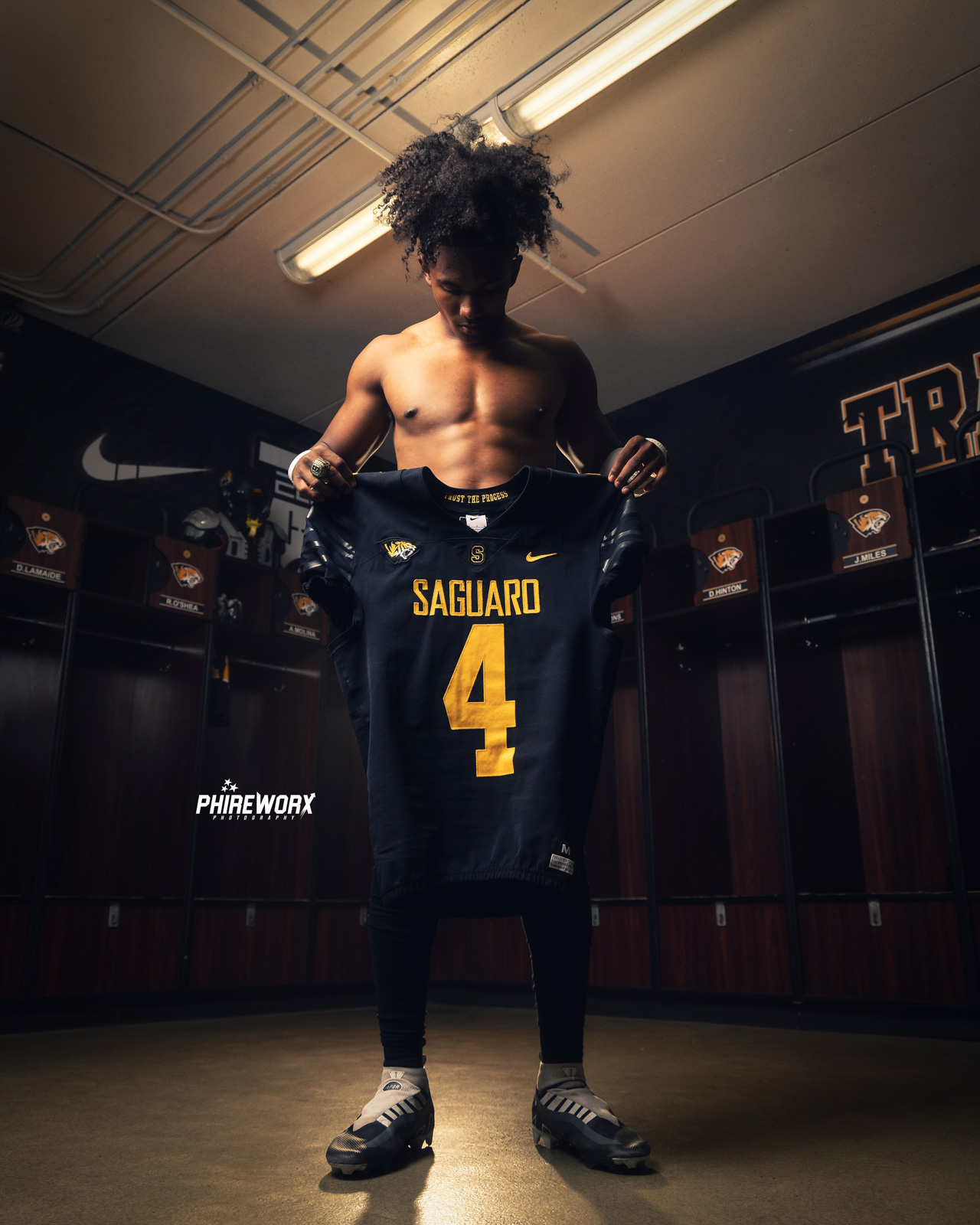 Saguaro player holding jersey in locker room — Media Day